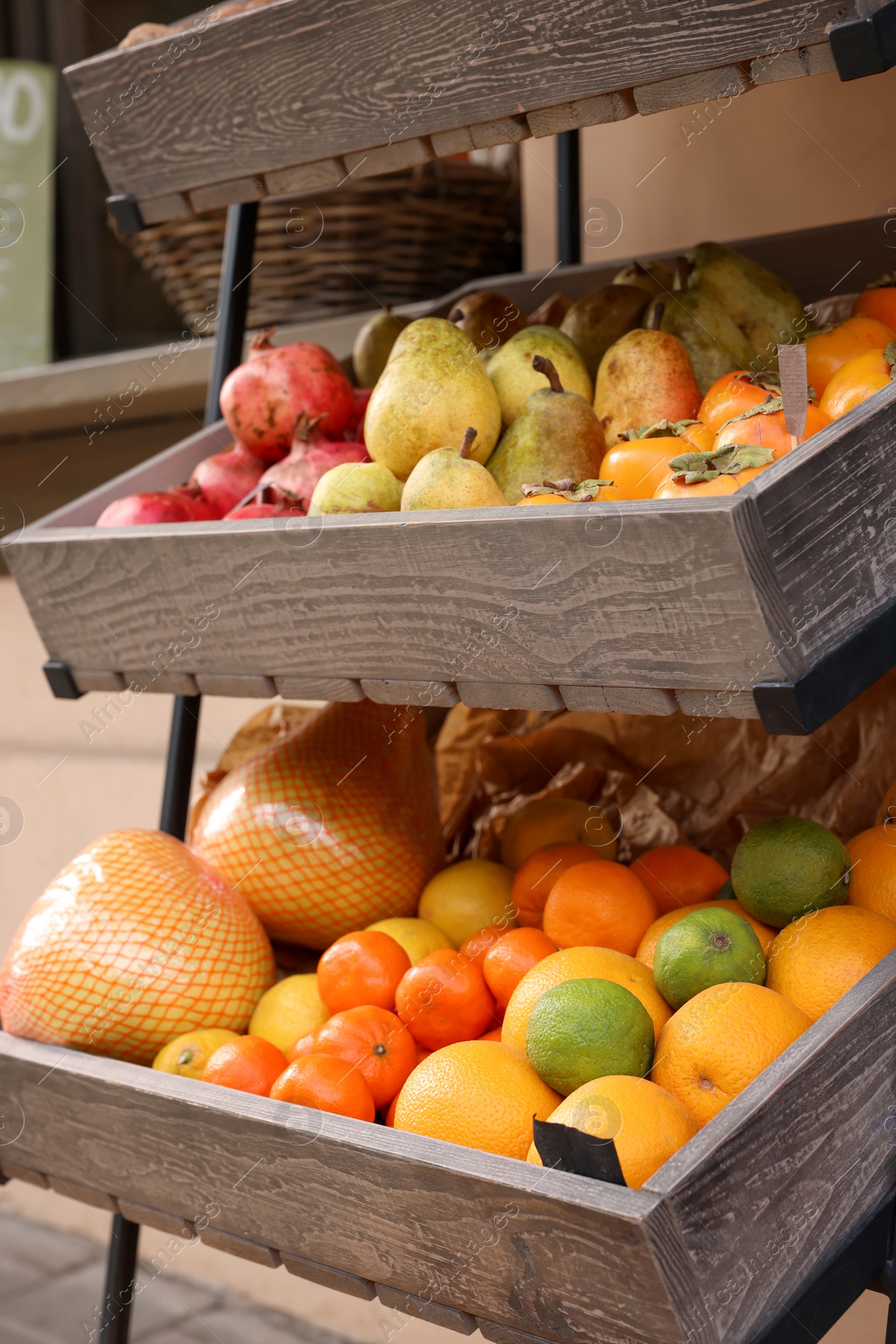 Photo of Fresh ripe fruits in wooden crates at market