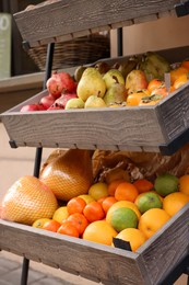Fresh ripe fruits in wooden crates at market