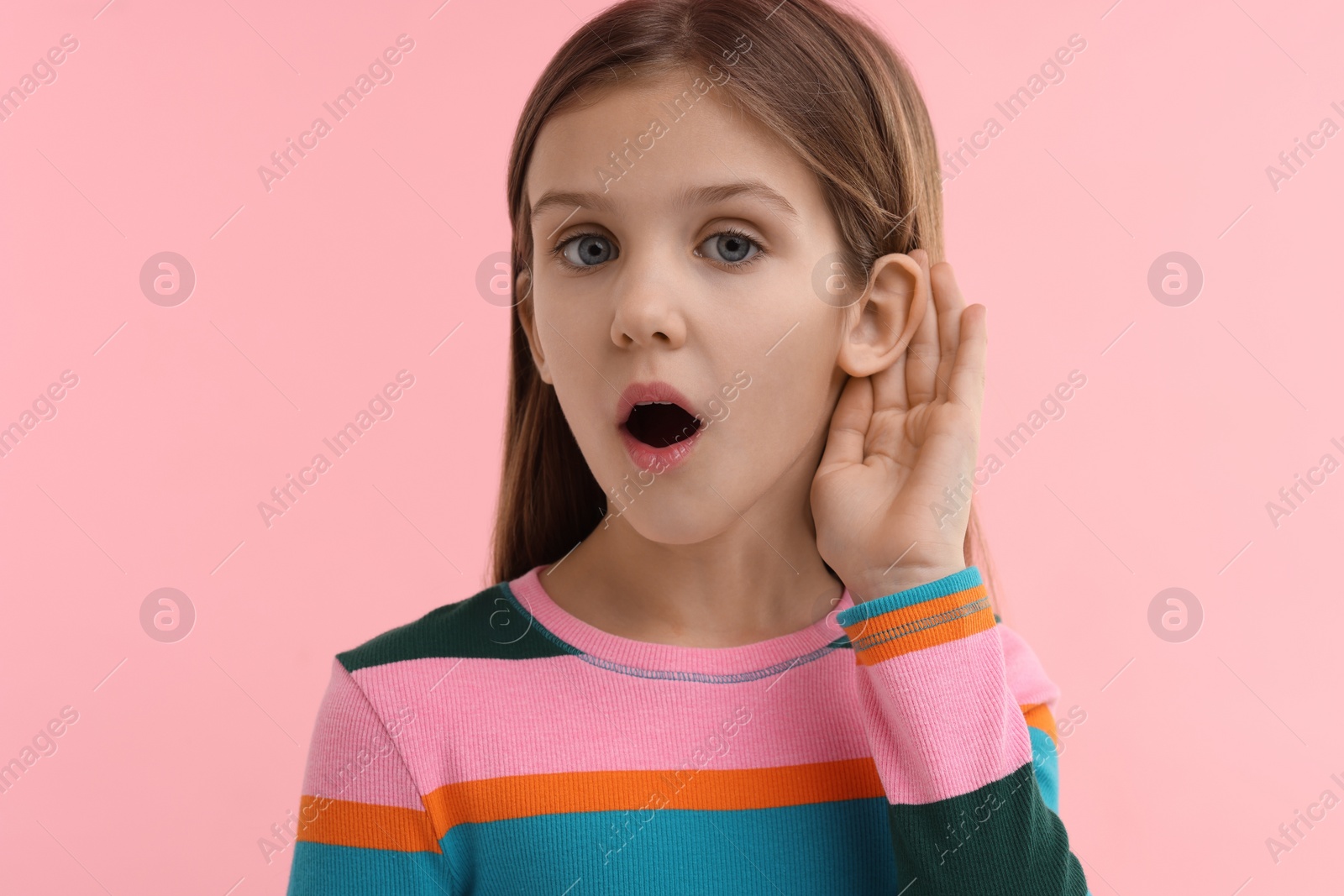 Photo of Little girl with hearing problem on pink background