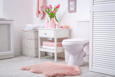 Photo of Interior of stylish bathroom with toilet bowl and decor elements