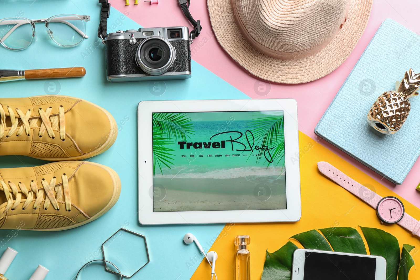 Photo of Flat lay composition with tablet and travel blogger's stuff on color background