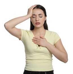 Photo of Young woman suffering from headache on white background. Cold symptoms