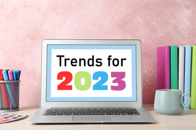 Image of Trends For 2023 text on laptop display monitor. Modern device on table