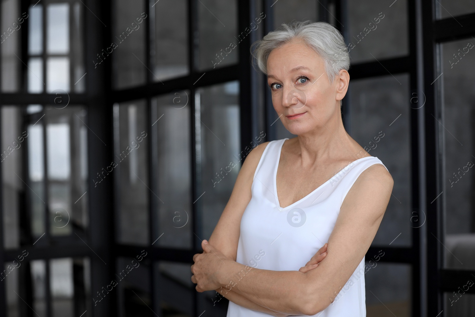 Photo of Portrait of happy mature woman indoors, space for text. Smart aging