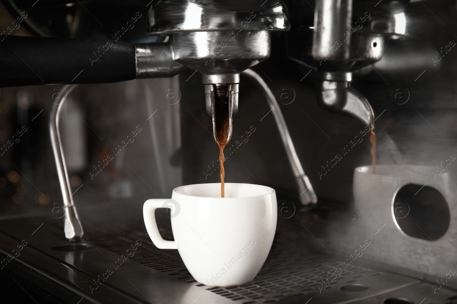 Photo of Making fresh aromatic espresso using professional coffee machine