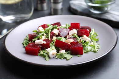 Delicious beet salad served on black table, closeup