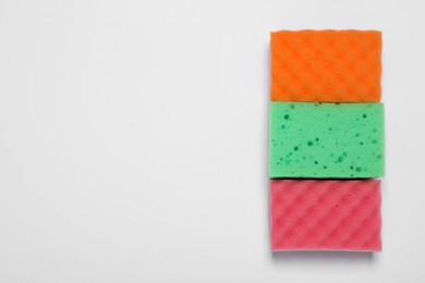 Sponges on white background, flat lay. Space for text