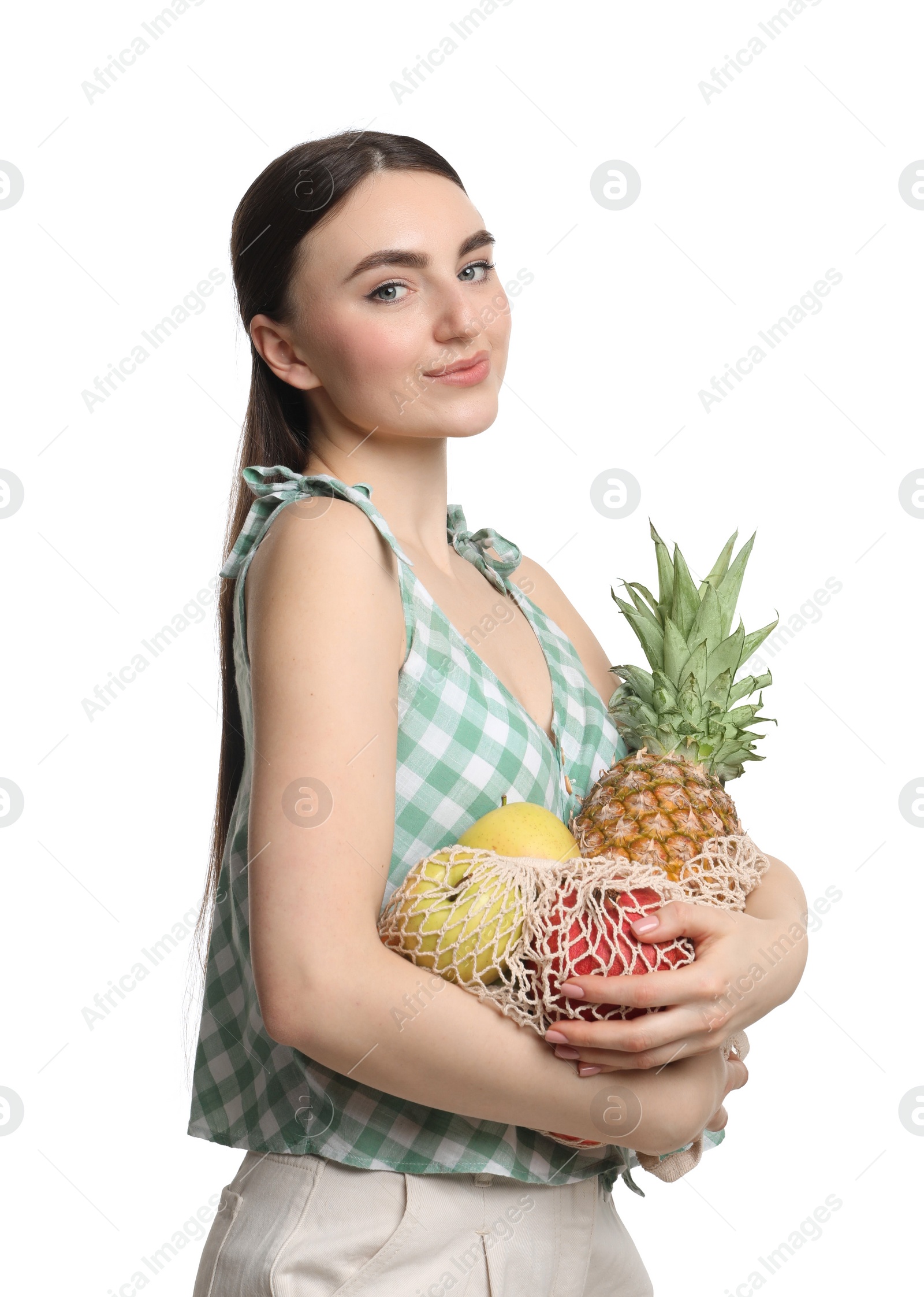 Photo of Woman with string bag of fresh fruits on white background