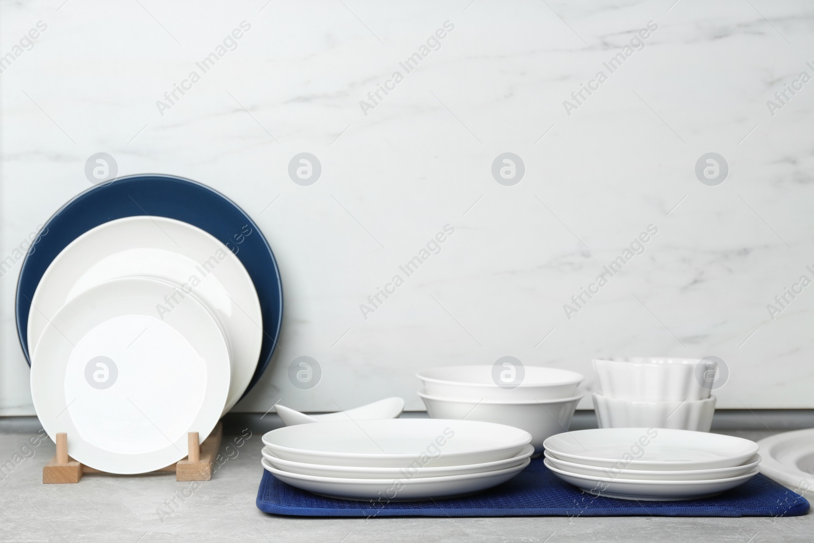 Photo of Different clean plates on counter in kitchen
