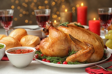 Photo of Traditional festive dinner with delicious roasted turkey served on table