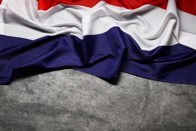 Flag of Netherlands on gray background, top view. Space for text