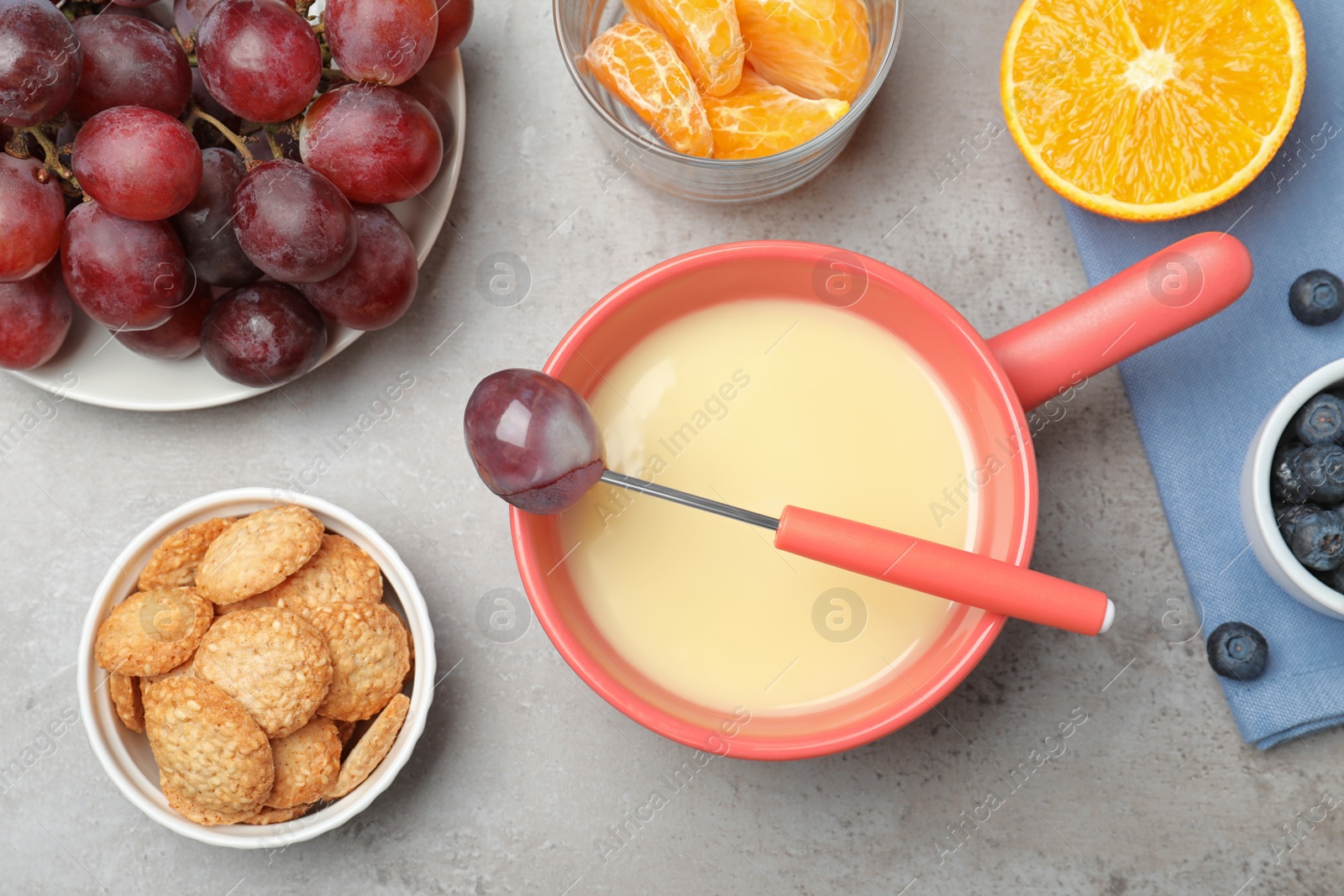 Photo of Flat lay composition with white chocolate fondue on grey stone background