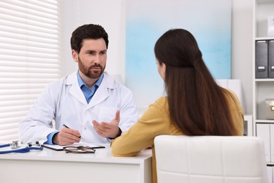 Photo of Doctor consulting patient during appointment in clinic