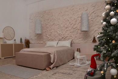 Photo of Bedroom interior with Christmas tree and festive decor