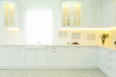 Photo of Blurred view of modern kitchen interior with stylish furniture