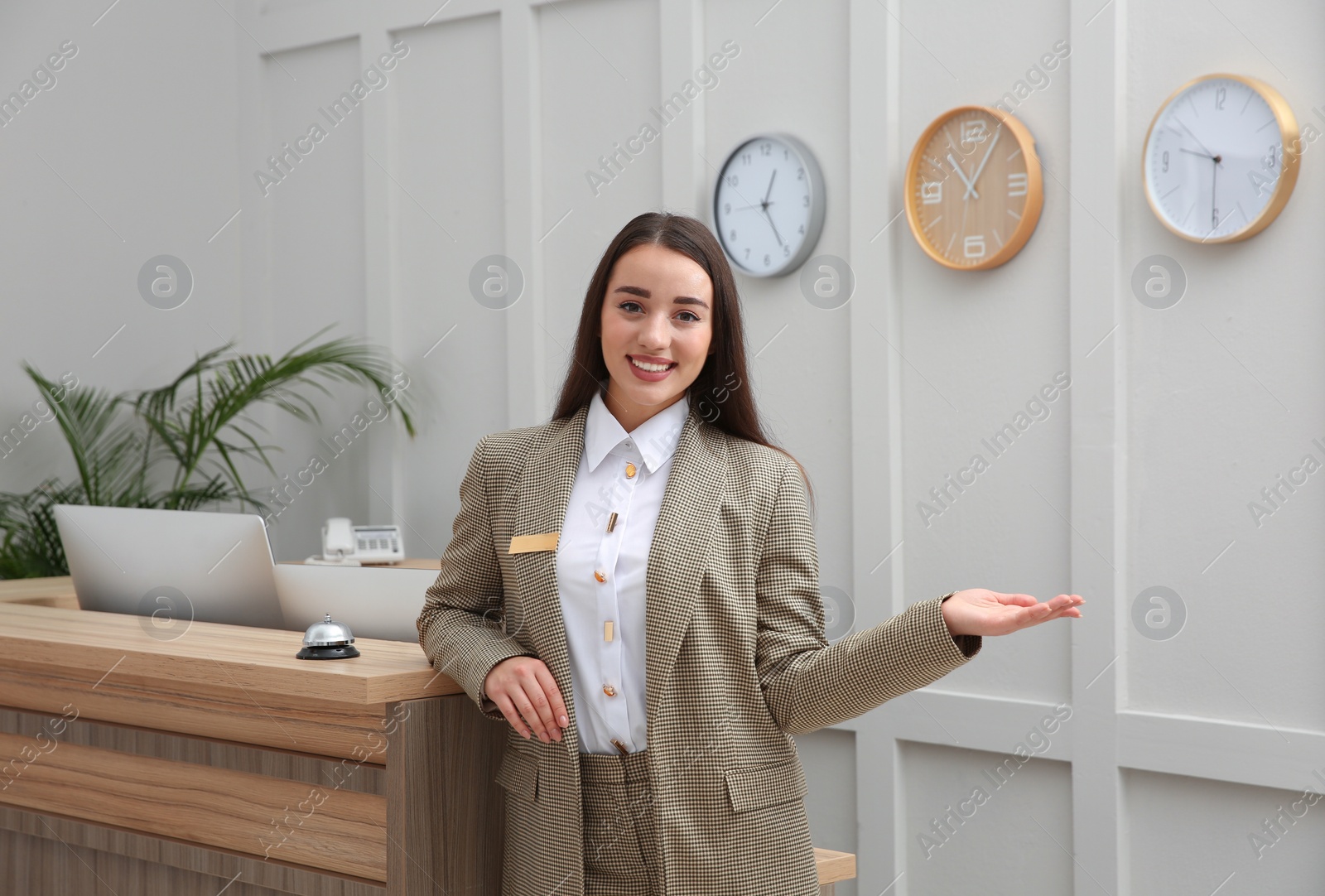 Photo of Portrait of beautiful receptionist near counter in hotel