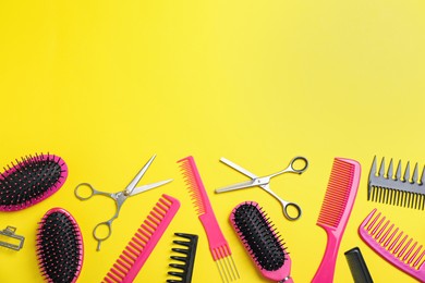 Photo of Flat lay composition with professional scissors and other hairdresser's equipment on yellow background, space for text. Haircut tool