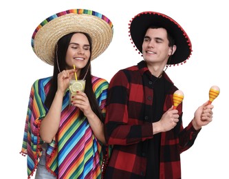 Lovely couple in Mexican sombrero hats with cocktail and maracas on white background