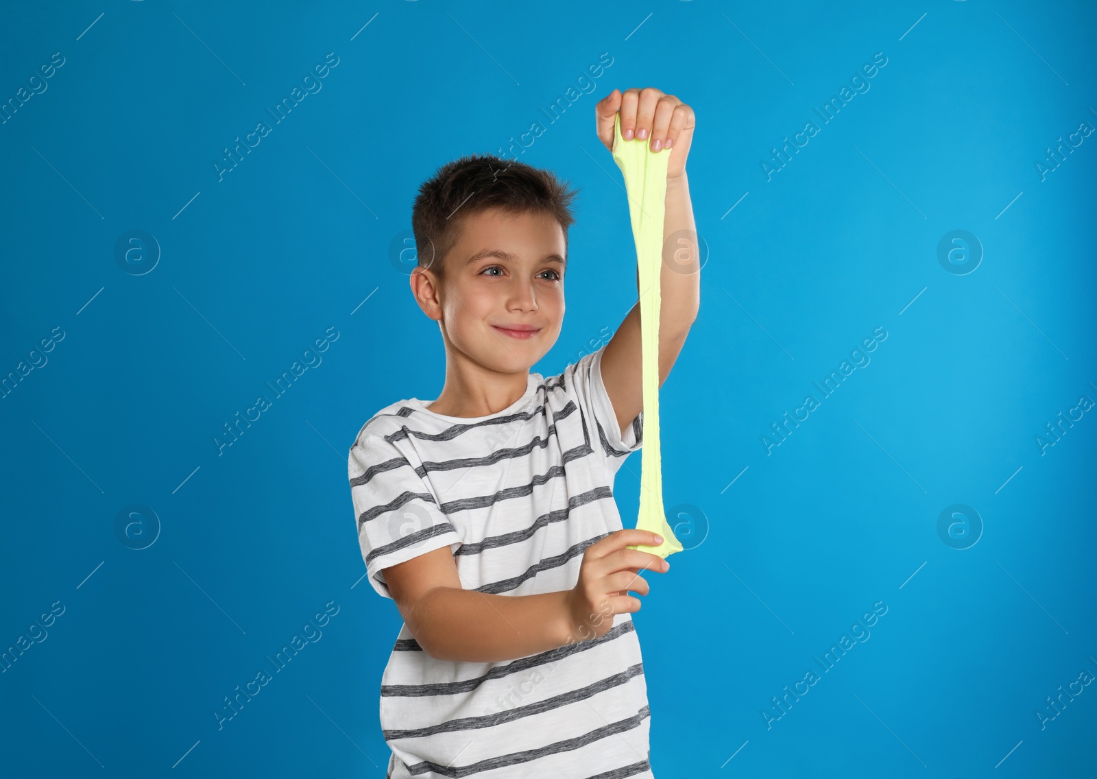 Photo of Little boy with slime on blue background