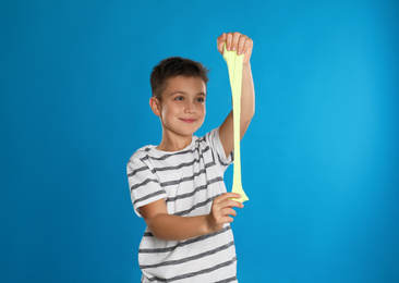 Photo of Little boy with slime on blue background