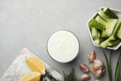 Photo of Flat lay composition with cucumber sauce and ingredients on grey background. Space for text