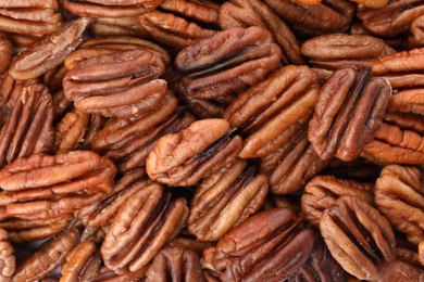 Photo of Shelled pecan nuts as background, top view. Nutritive food