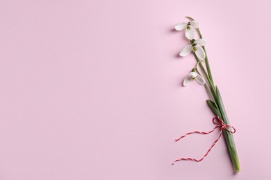 Photo of Beautiful snowdrops on pink background, top view. Space for text