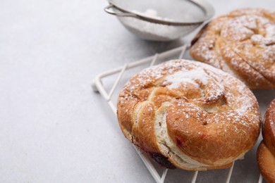 Different delicious rolls on light table, closeup and space for text. Sweet buns