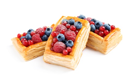 Fresh delicious puff pastry with sweet berries on white background