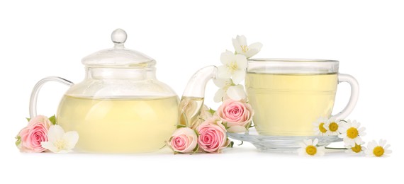 Photo of Aromatic herbal tea in glass cup, teapot and flowers isolated on white