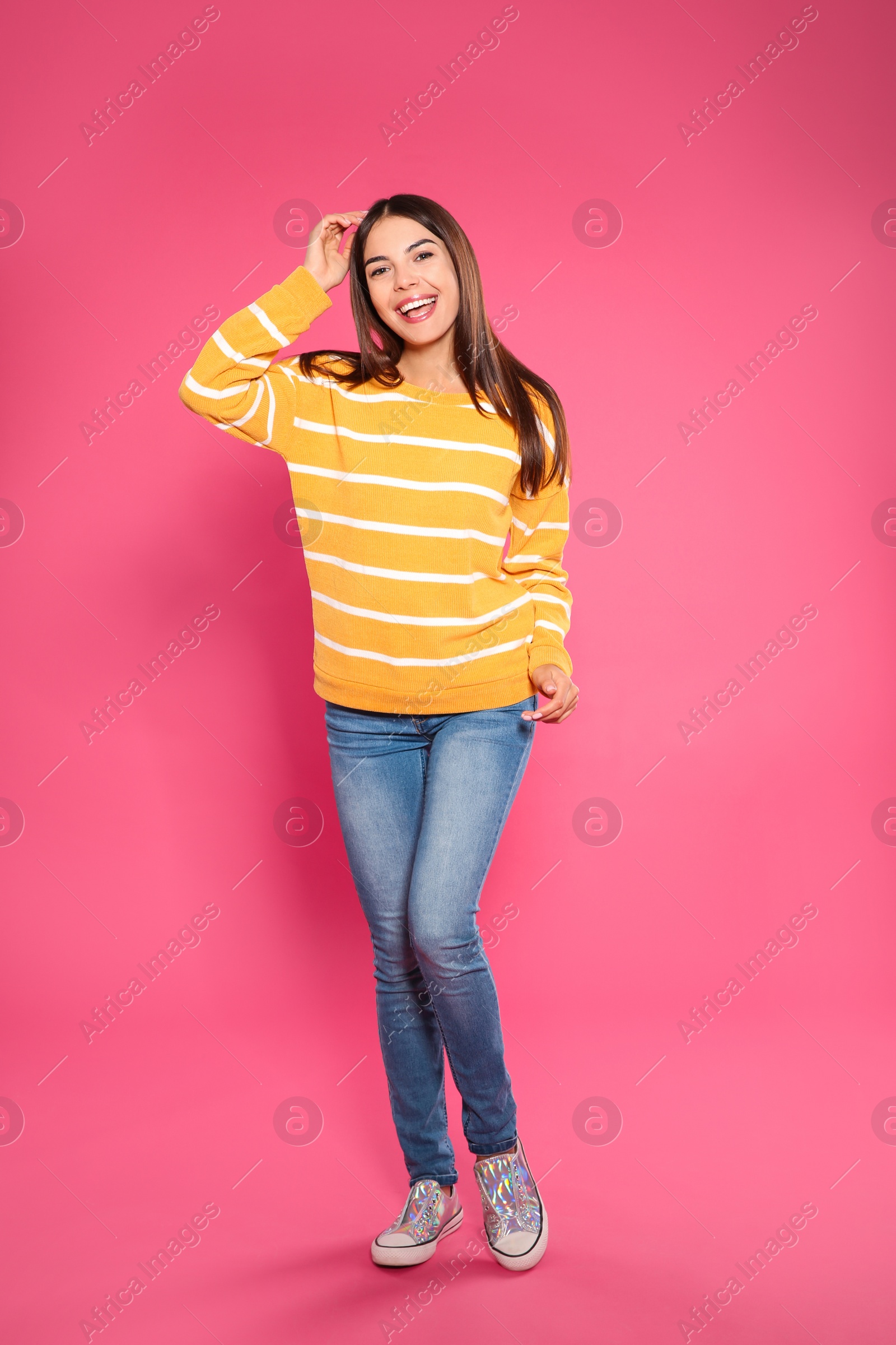 Photo of Full length portrait of emotional woman on color background