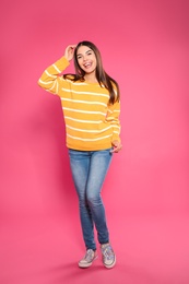 Photo of Full length portrait of emotional woman on color background