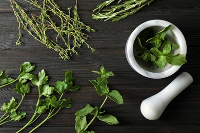 Different fresh herbs on wooden table, top view