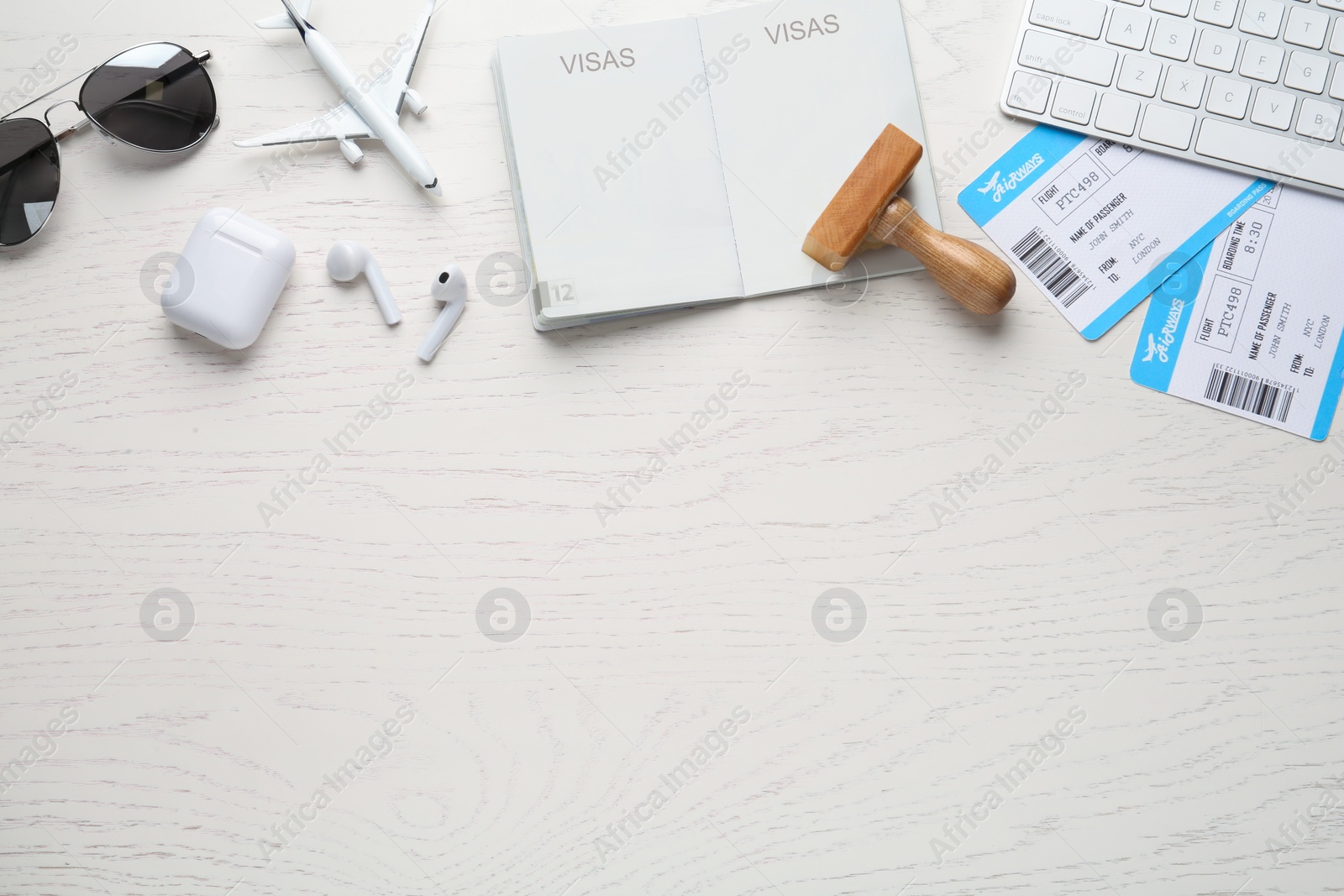 Photo of Flat lay composition with passport, stamp and flight tickets on white wooden table, space for text