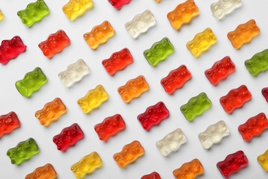 Photo of Delicious color jelly bears on white background, top view