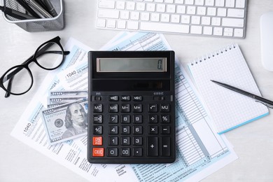 Tax accounting. Flat lay composition with calculator and documents on light grey table