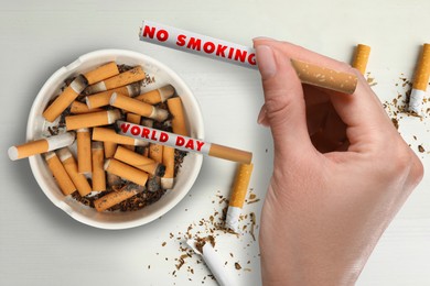 Image of World No Smoking Day. Woman with cigarette near ashtray on white background, top view