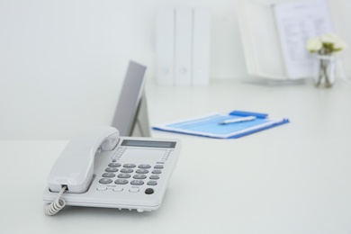 Photo of Stationary phone on reception desk in hospital