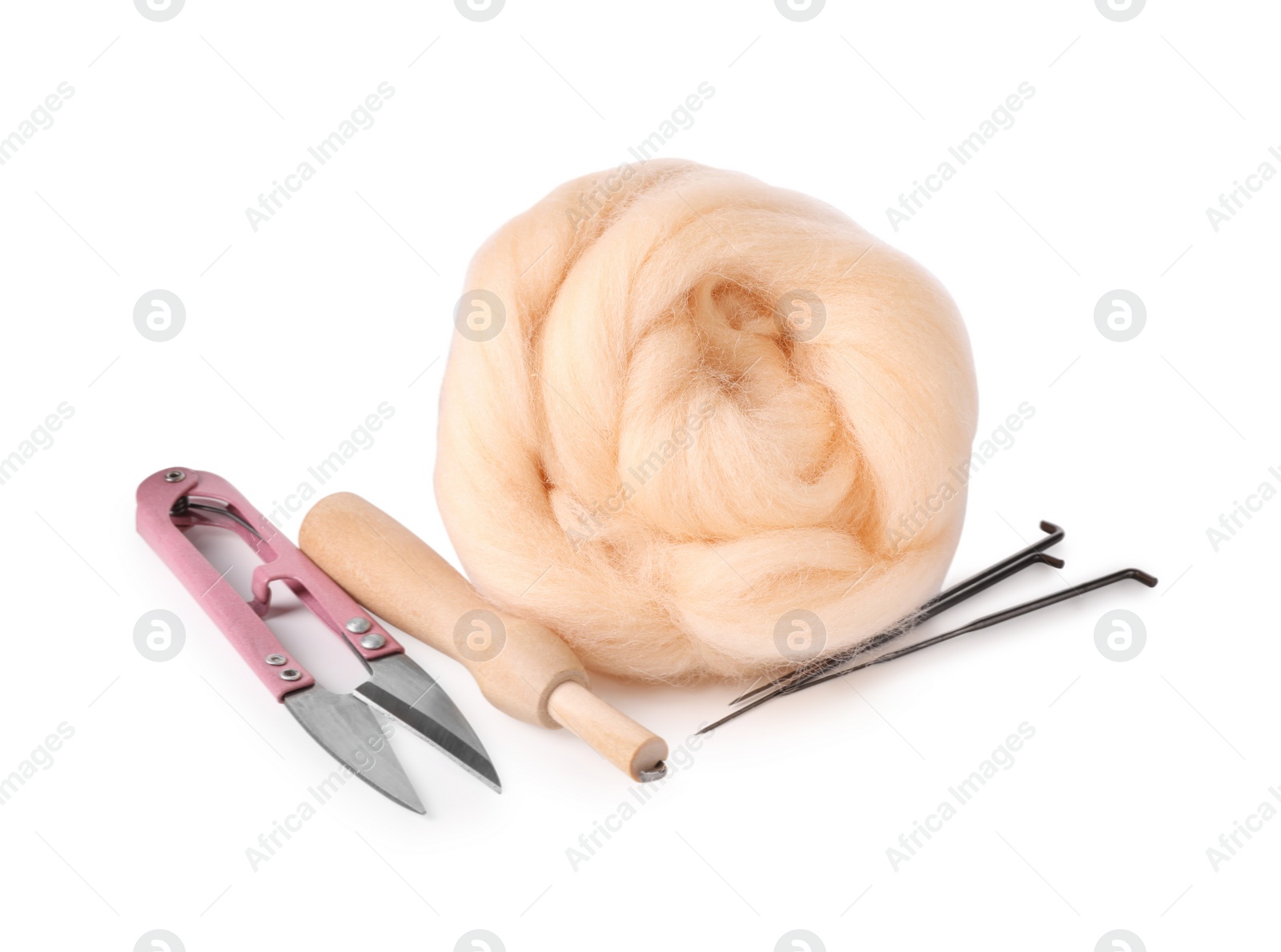 Photo of Beige felting wool, scissors and needles isolated on white