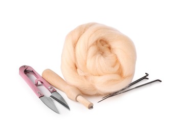 Photo of Beige felting wool, scissors and needles isolated on white
