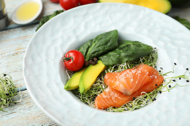 Photo of Delicious salmon with spinach served on table, closeup