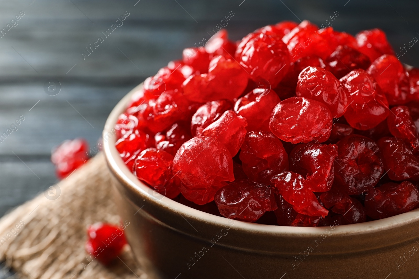 Photo of Bowl with tasty cherries on wooden background, closeup. Dried fruits as healthy food