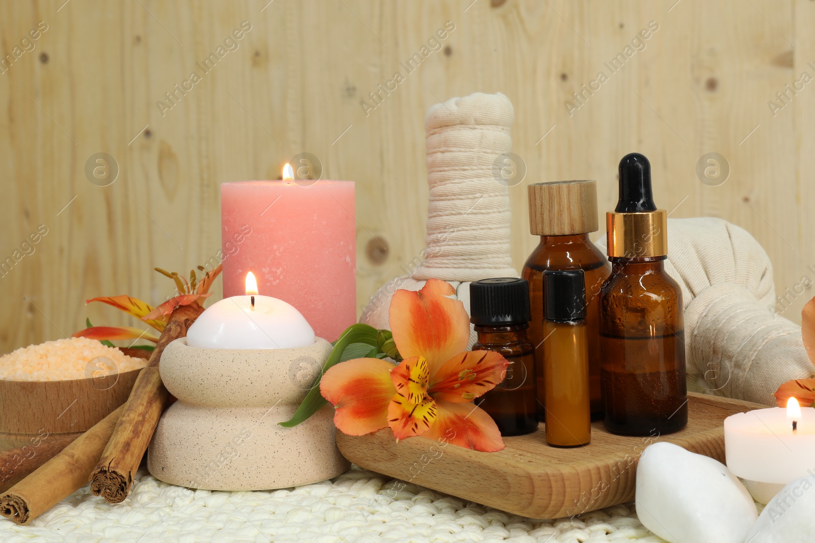 Photo of Different aromatherapy products and burning candles on table