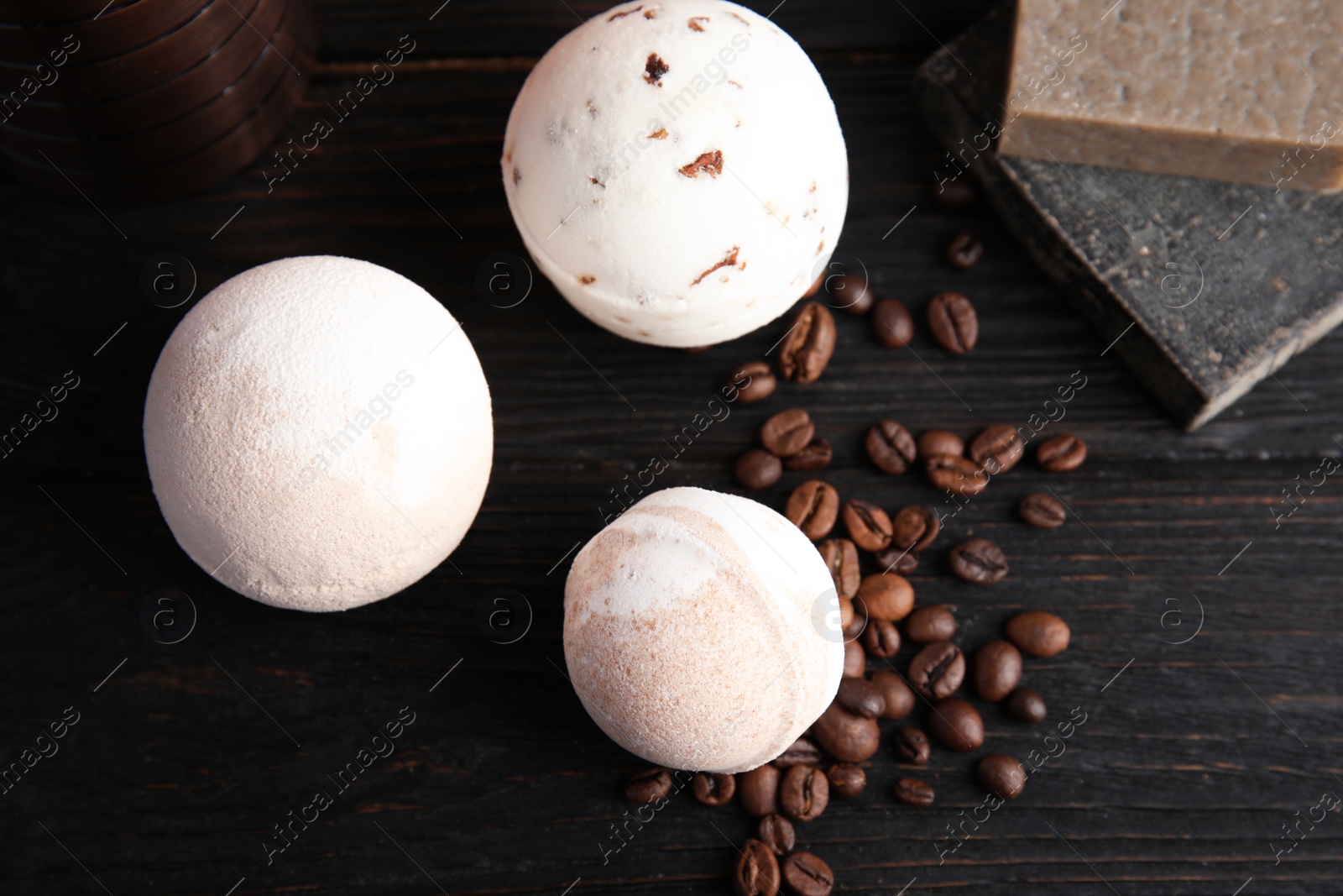 Photo of Flat lay composition with bath bombs, soap bars and coffee beans on wooden background