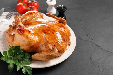 Tasty roasted chicken with parsley served on grey textured table, space for text