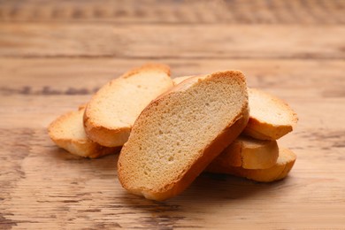 Photo of Tasty hard chuck crackers on wooden table, closeup