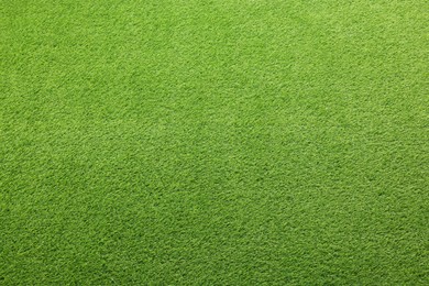 Photo of Green artificial grass as background, top view