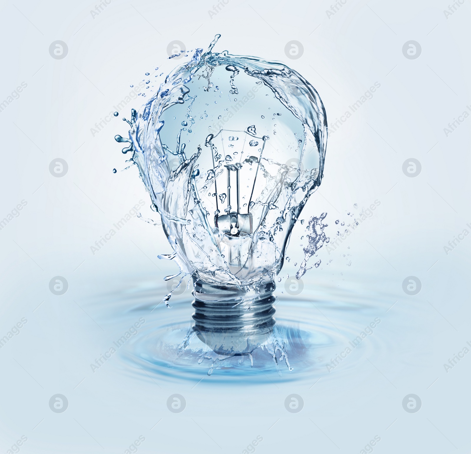 Image of Light bulb with water splashes on light background. Alternative energy source