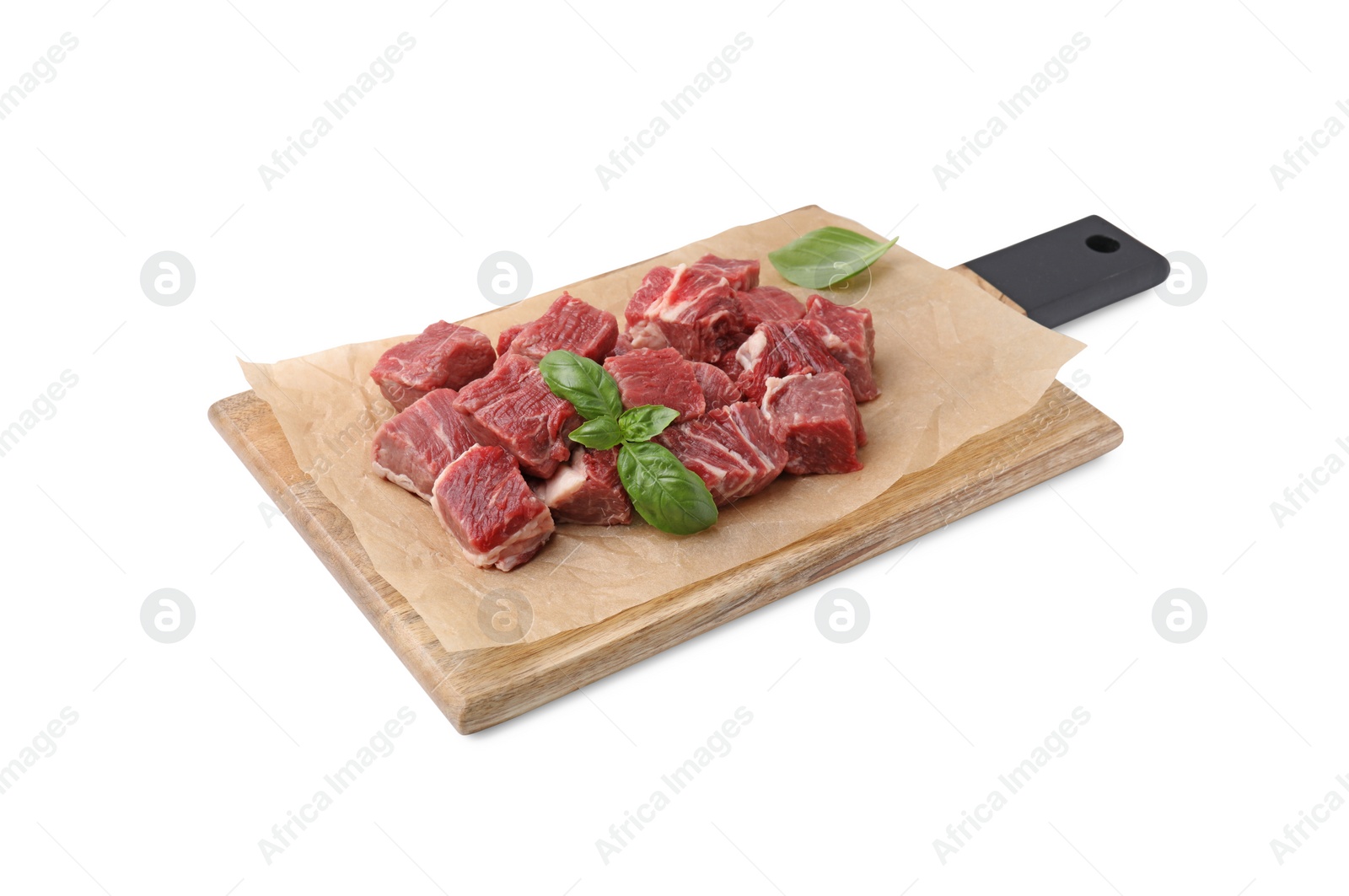 Photo of Wooden board with cut fresh beef meat and basil leaves isolated on white