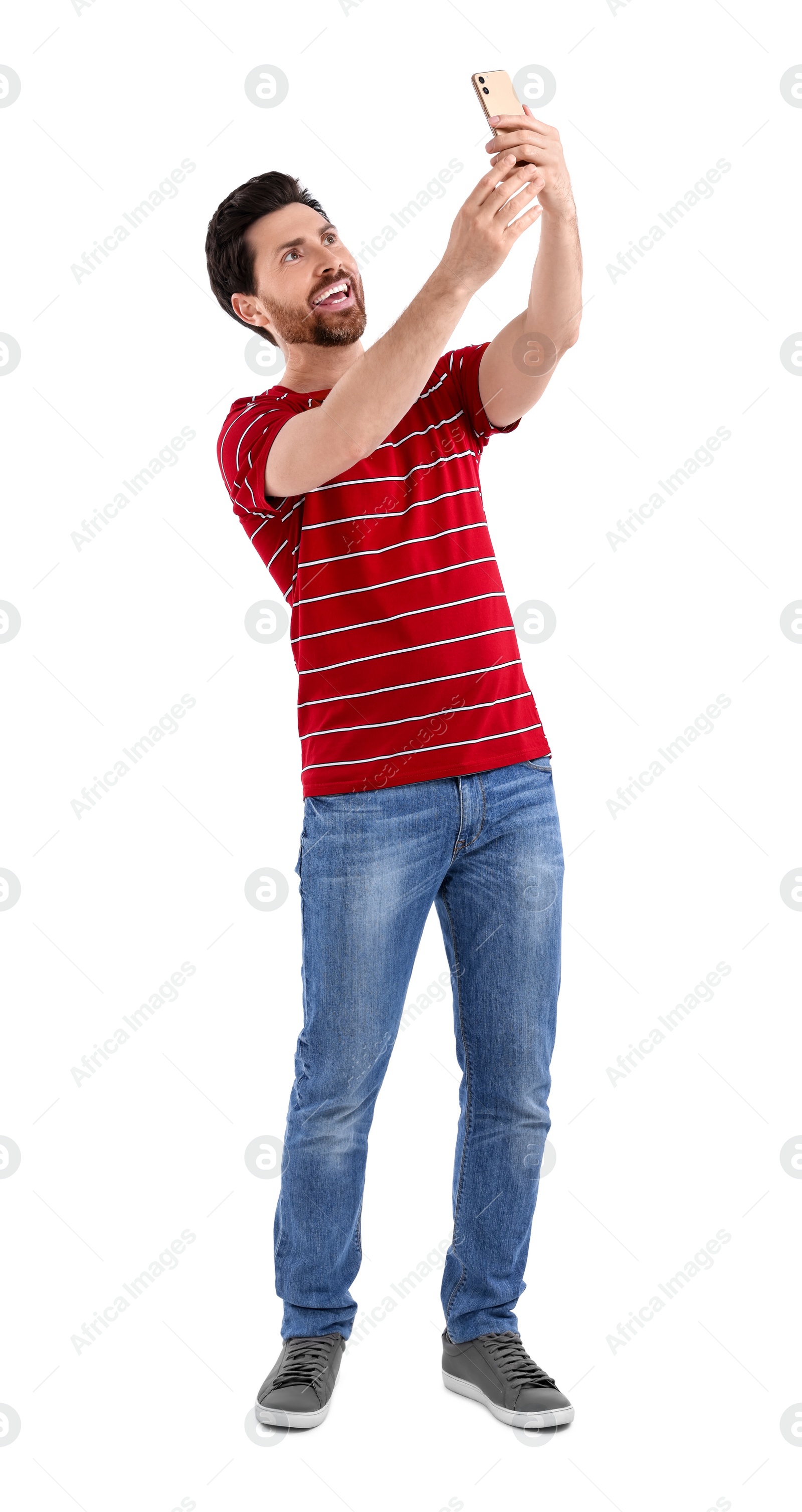 Photo of Smiling man taking selfie with smartphone on white background